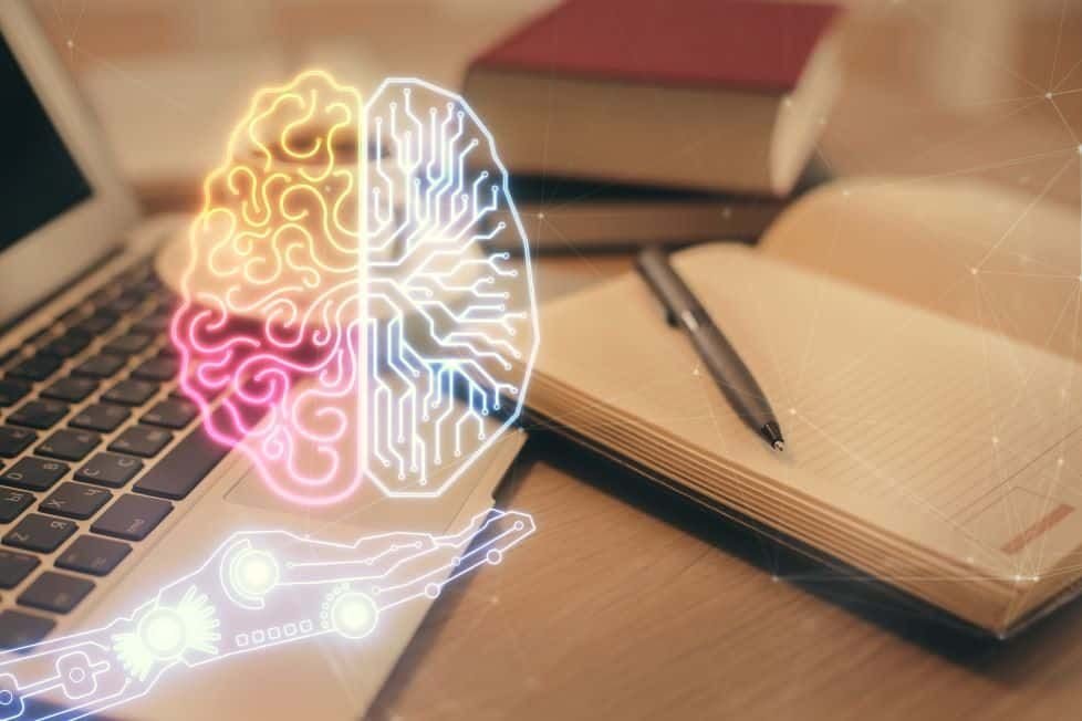 Ilustración de un cerebro sobre una laptop y libros abiertos